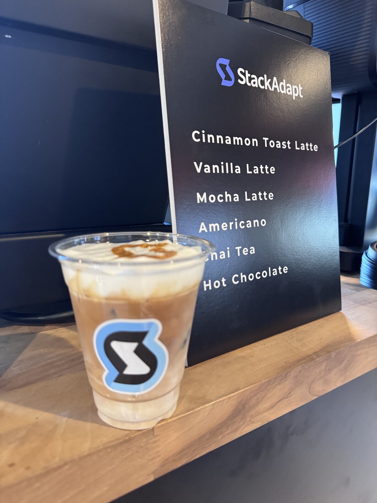 Custom branded iced coffee cup at a StackAdapt event