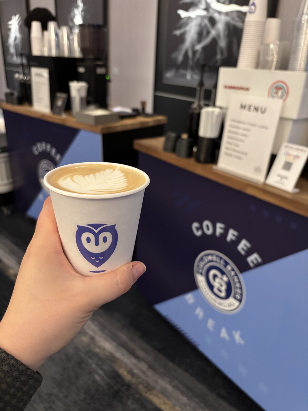 Custom branded hot coffee cup at an event