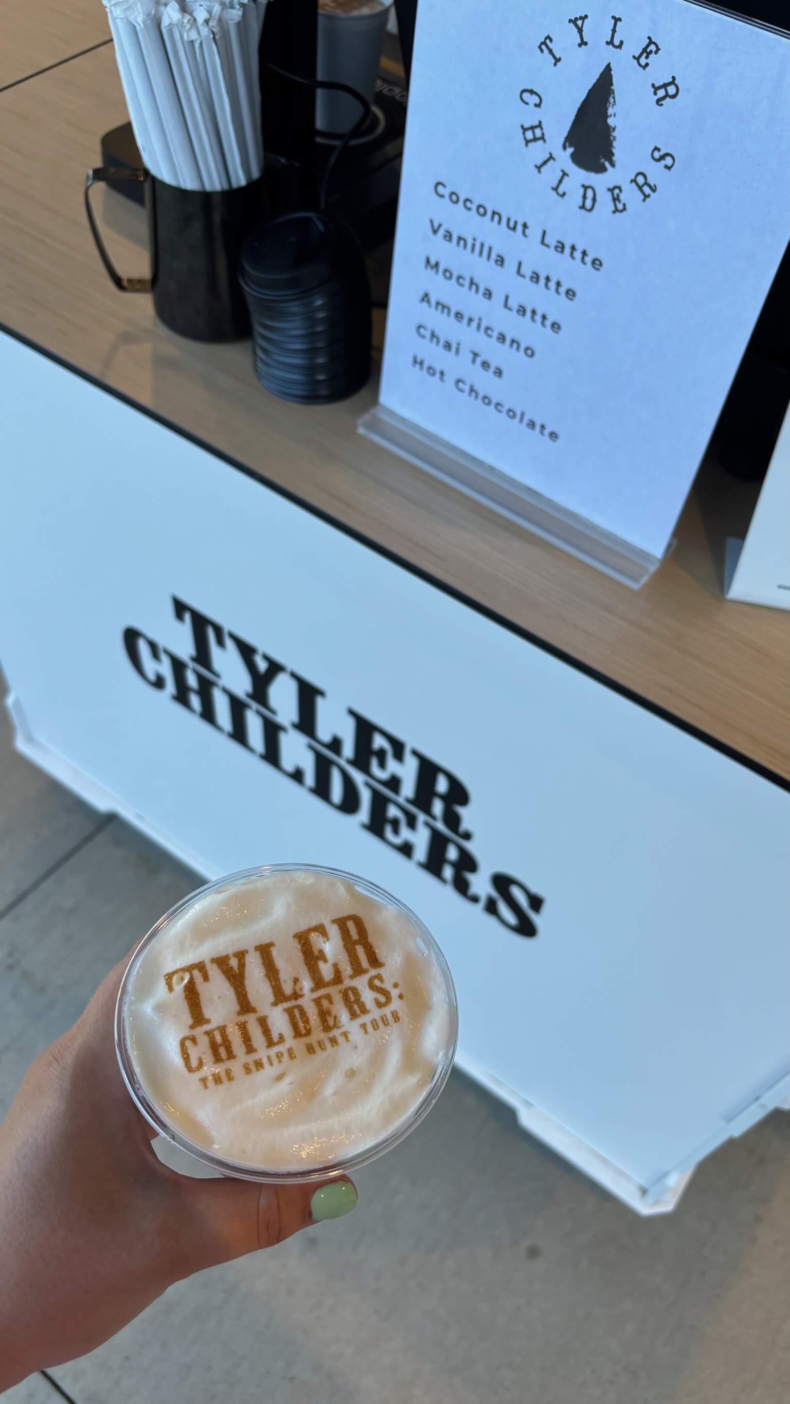 Tyler Childers custom latte displayed in front of the branded coffee cart at Morton Amphitheater